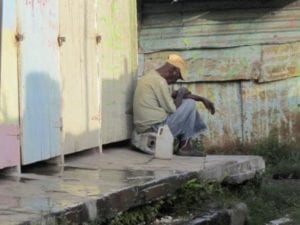 An eldery resident of Majesty gardens chills outside his residence which is nestled in the former constituency of Portia Simpson Miller