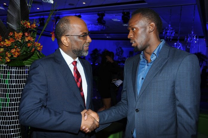 Earl Jarrett greets Usain Bolt - Caribbean National Weekly News