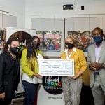 David I. Muir and Calibe Thompson of Island SPACE (left) receiving a $10,000 underwriting check from Donna Callender and Derrick Records of GraceKennedy USA LLC. (1)