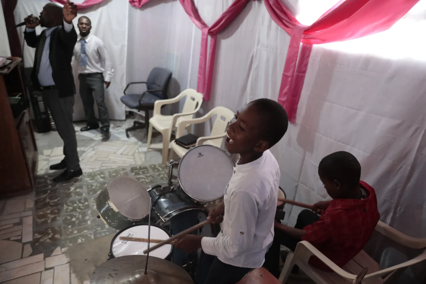 Woodberson-Seide-happily-playing-the-drums-in-a-Haitian-church