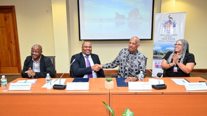 Professor Mzubanzi Bismark Tyobkeka (2nd from left) Principal and Vice-Chancellor, North-West University, South Africa and Professor Sir Hilary Beckles (2nd from right) Vice-Chancellor, The University of the West Indies, shake hands following the signing of a MOU between the two institutions at The UWI Regional Headquarters, Mona.